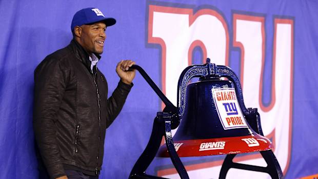 Nov 14, 2016; East Rutherford, NJ, USA; New York Giants former defensive end Michael Strahan rings a bell before a game between the New York Giants and the Cincinnati Bengals at MetLife Stadium.